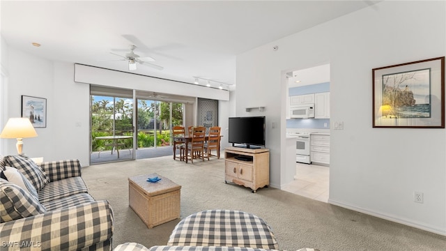 living room featuring ceiling fan, light carpet, and track lighting