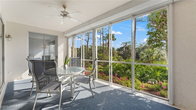 unfurnished sunroom with ceiling fan