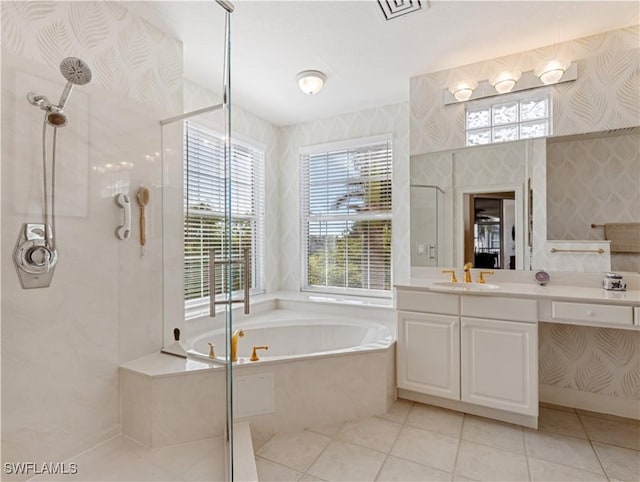 bathroom with tile patterned floors, vanity, and shower with separate bathtub