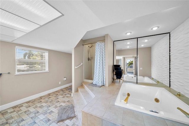 bathroom with a wealth of natural light and independent shower and bath