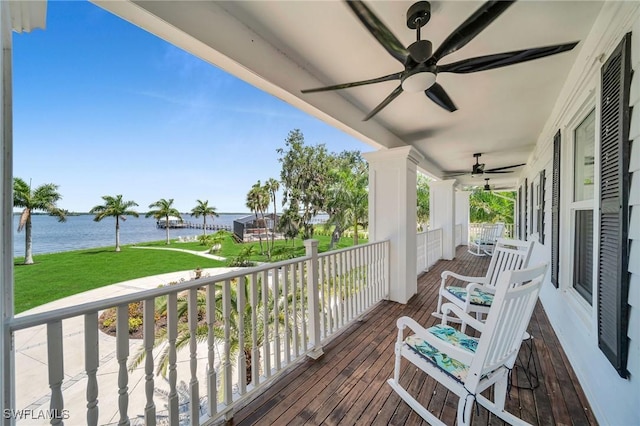 wooden terrace with a porch and a water view