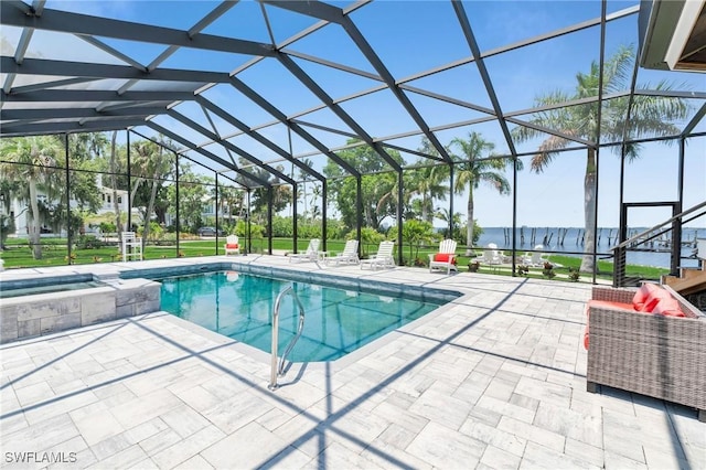 view of swimming pool featuring a patio area, a lanai, and an in ground hot tub