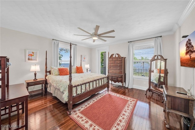 bedroom with ceiling fan, dark wood-type flooring, and ornamental molding