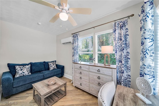 living room featuring a wall mounted AC, ceiling fan, and light hardwood / wood-style floors