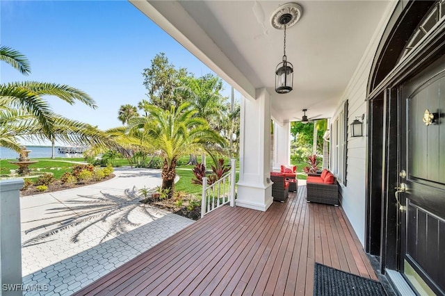 deck with a water view and a porch