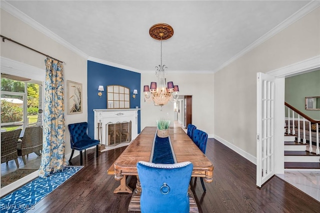 dining room featuring ornamental molding, dark hardwood / wood-style floors, and a notable chandelier