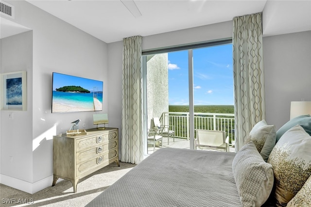 bedroom with light carpet and access to outside