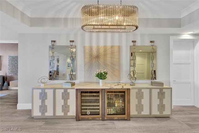 bar with wine cooler, wood-type flooring, and a chandelier