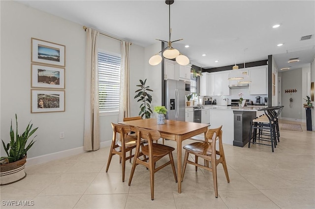 dining space featuring light tile patterned floors