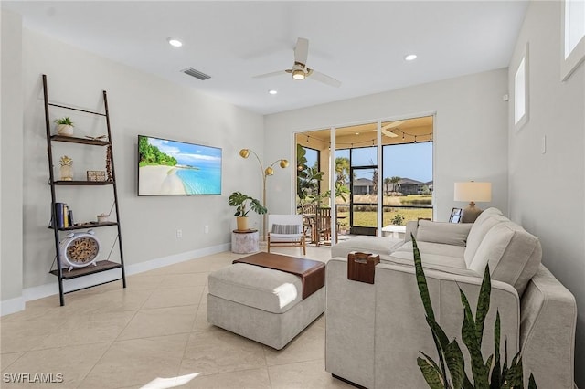 living room with ceiling fan and light tile patterned flooring