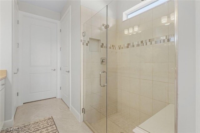 bathroom featuring tile patterned flooring, vanity, and an enclosed shower