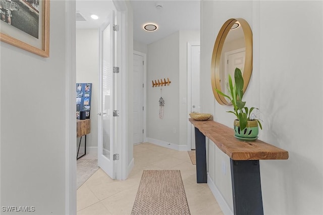 hallway featuring light tile patterned floors