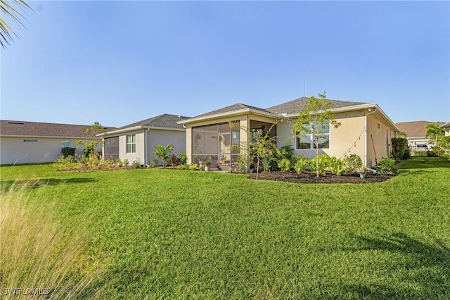 view of front of home with a front yard and a sunroom