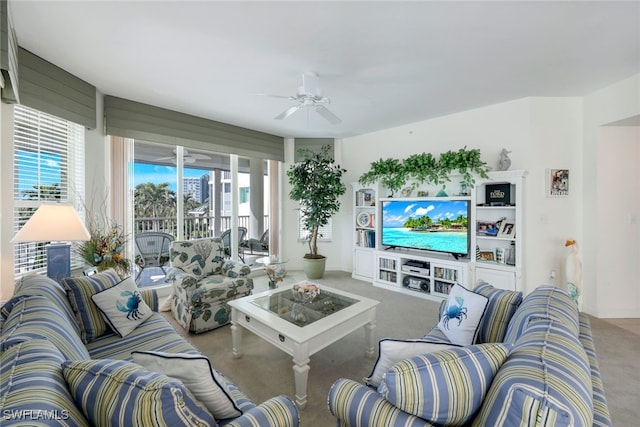 carpeted living room with ceiling fan