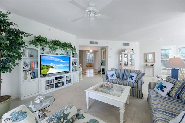 carpeted living room with ceiling fan