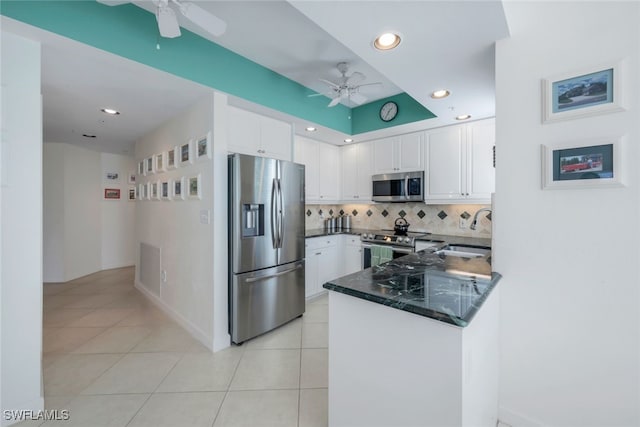 kitchen featuring white cabinets, kitchen peninsula, sink, and appliances with stainless steel finishes