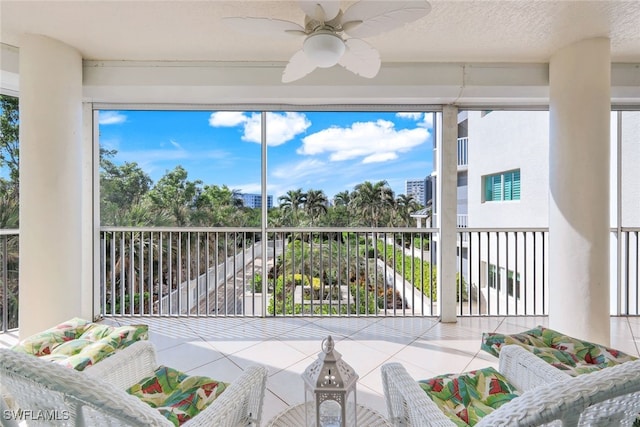 sunroom featuring ceiling fan