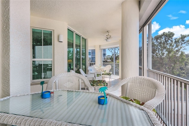 sunroom featuring ceiling fan