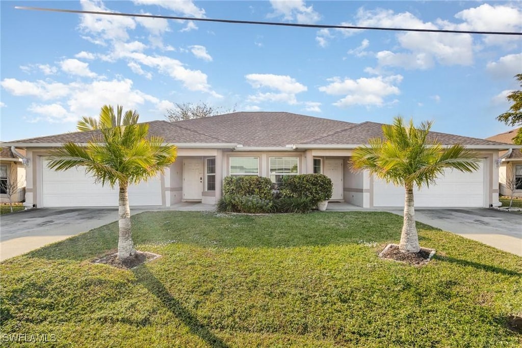 ranch-style home with a front yard and a garage