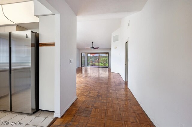 hallway with high vaulted ceiling and parquet floors