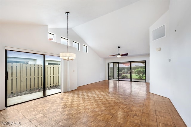 unfurnished living room with light parquet floors, high vaulted ceiling, and ceiling fan