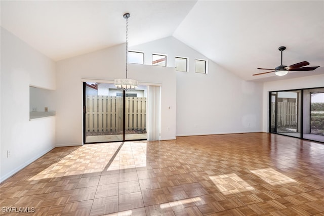 entrance foyer with parquet floors, ceiling fan with notable chandelier, and high vaulted ceiling