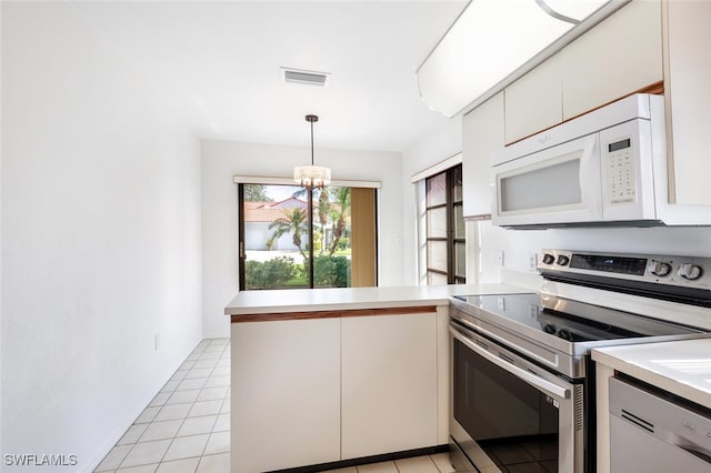 kitchen with kitchen peninsula, white cabinets, stainless steel electric range oven, and hanging light fixtures