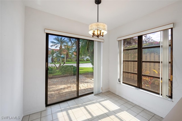 unfurnished dining area featuring light tile patterned floors and an inviting chandelier