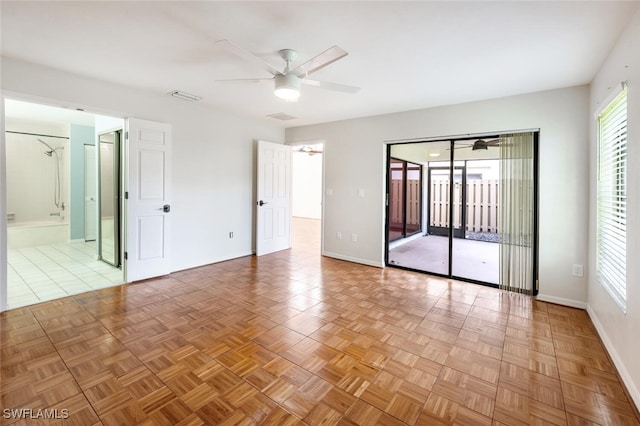 unfurnished room with ceiling fan and light parquet flooring