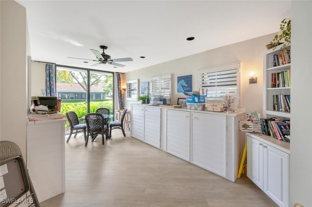 kitchen featuring light wood-type flooring, white cabinetry, and ceiling fan