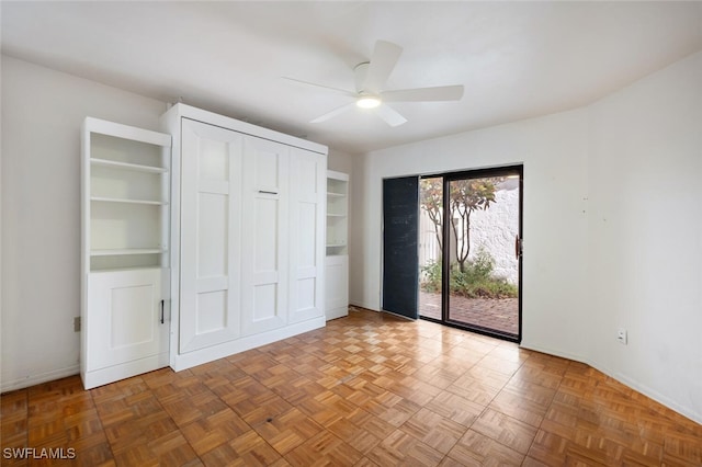 unfurnished bedroom with access to exterior, ceiling fan, and parquet floors