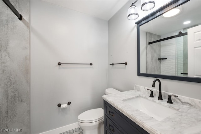 bathroom with tile patterned floors, vanity, toilet, and a shower with door