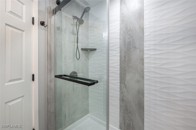 bathroom featuring a shower with shower door