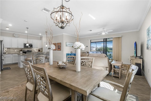 dining room featuring light tile patterned floors, ceiling fan with notable chandelier, and ornamental molding