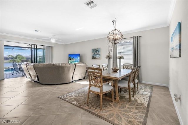 dining space featuring ceiling fan with notable chandelier, light tile patterned flooring, and ornamental molding