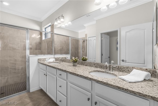 bathroom with tile patterned flooring, vanity, crown molding, and a shower with shower door