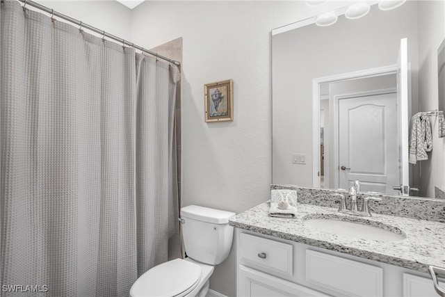 bathroom with a shower with curtain, vanity, and toilet