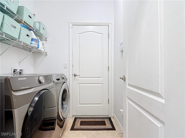 washroom featuring washing machine and clothes dryer and light tile patterned floors