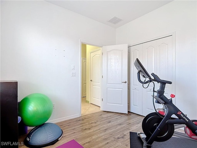 exercise area with light wood-type flooring