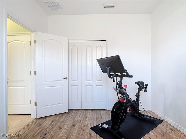 workout room featuring light hardwood / wood-style flooring