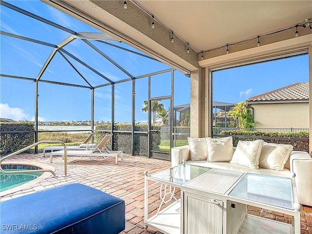 view of patio featuring outdoor lounge area and glass enclosure