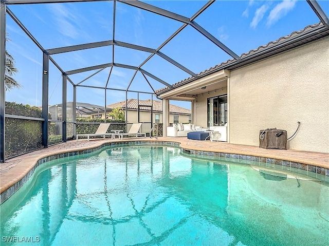 view of swimming pool featuring a lanai and a patio area