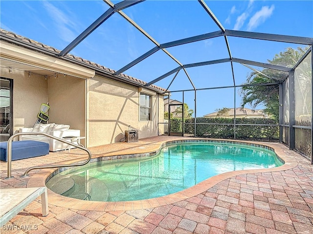 view of pool with a lanai and a patio area