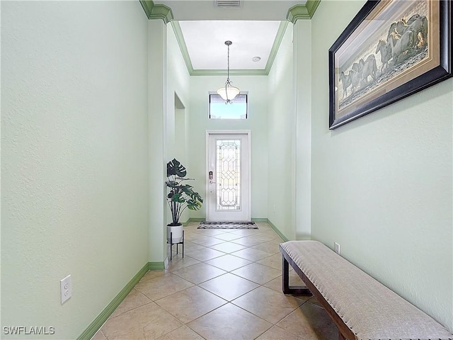 foyer entrance with ornamental molding and light tile patterned floors