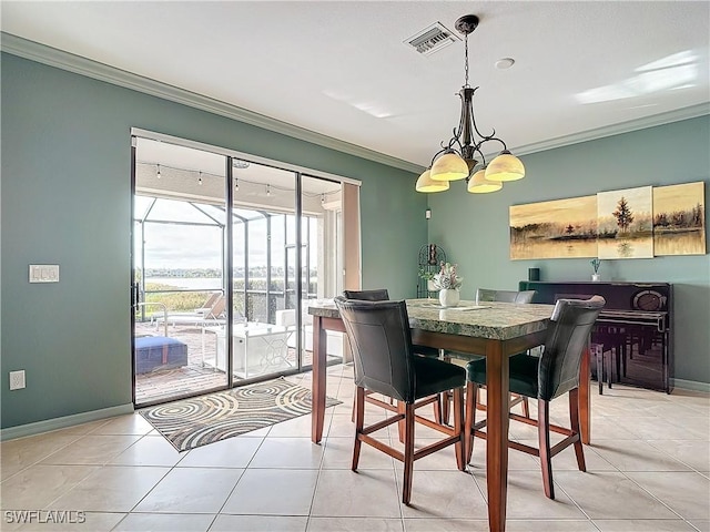 tiled dining room with a notable chandelier and ornamental molding