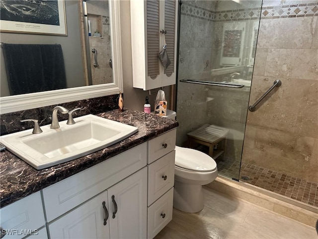 bathroom with vanity, tile patterned floors, toilet, and walk in shower