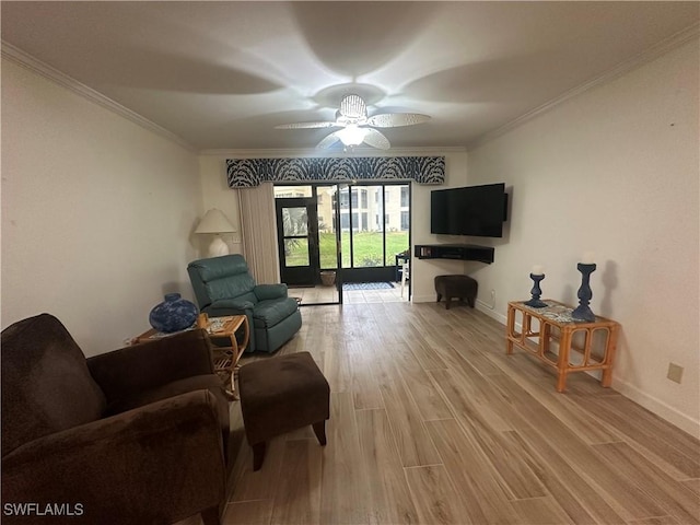 living room with ceiling fan, ornamental molding, and light hardwood / wood-style flooring