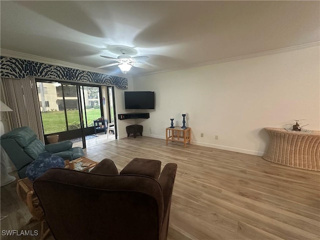 living area featuring ornamental molding, wood finished floors, and a ceiling fan