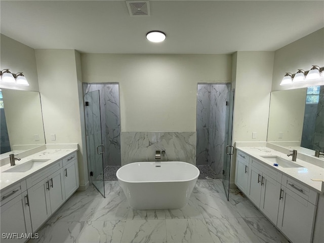 bathroom featuring plus walk in shower, vanity, and tile walls