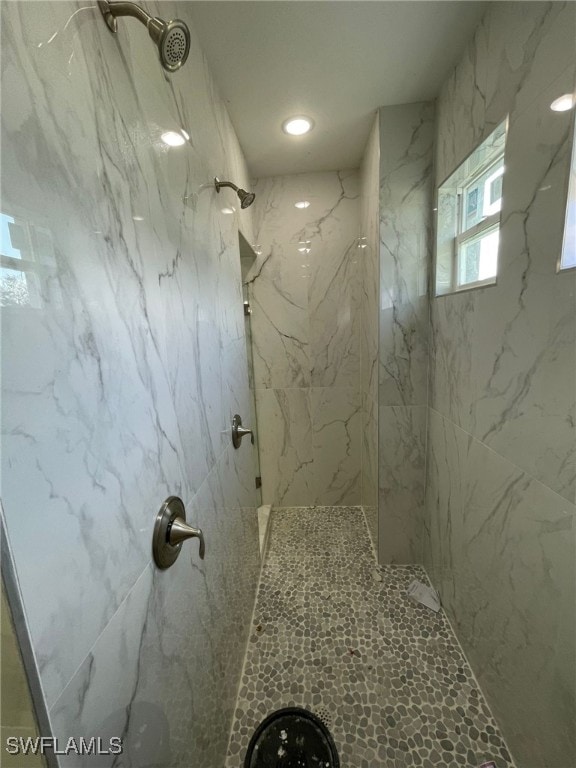 bathroom with a tile shower